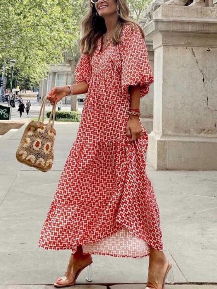 Women's elegant printed maxi dress with flattering waistband, perfect for summer style.
