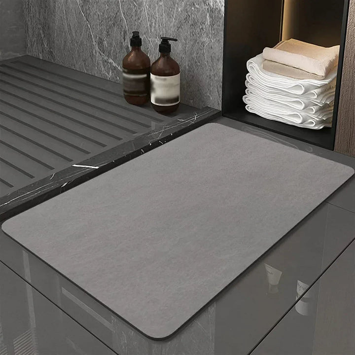 Anti-slip diatomite floor mat provides superior grip & quick drying for bathroom safety. Stylish & practical.