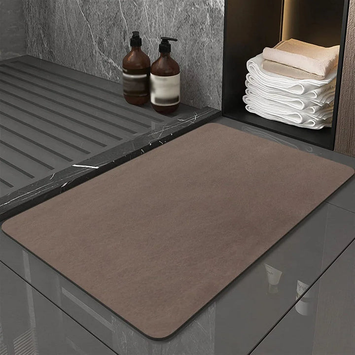 Absorbent diatomite bath mat in a modern bathroom setting. Eco-friendly & fast-drying for home safety.