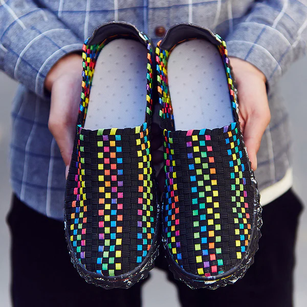 Woman walking outdoors wearing Eliana recycled comfort sneakers, showcasing their versatility & sustainable design.