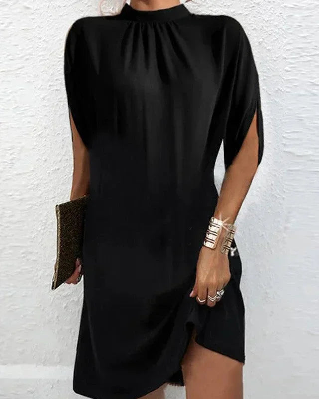 Versatile women's mini dress with a sophisticated mock neck and flowy cape sleeves.
