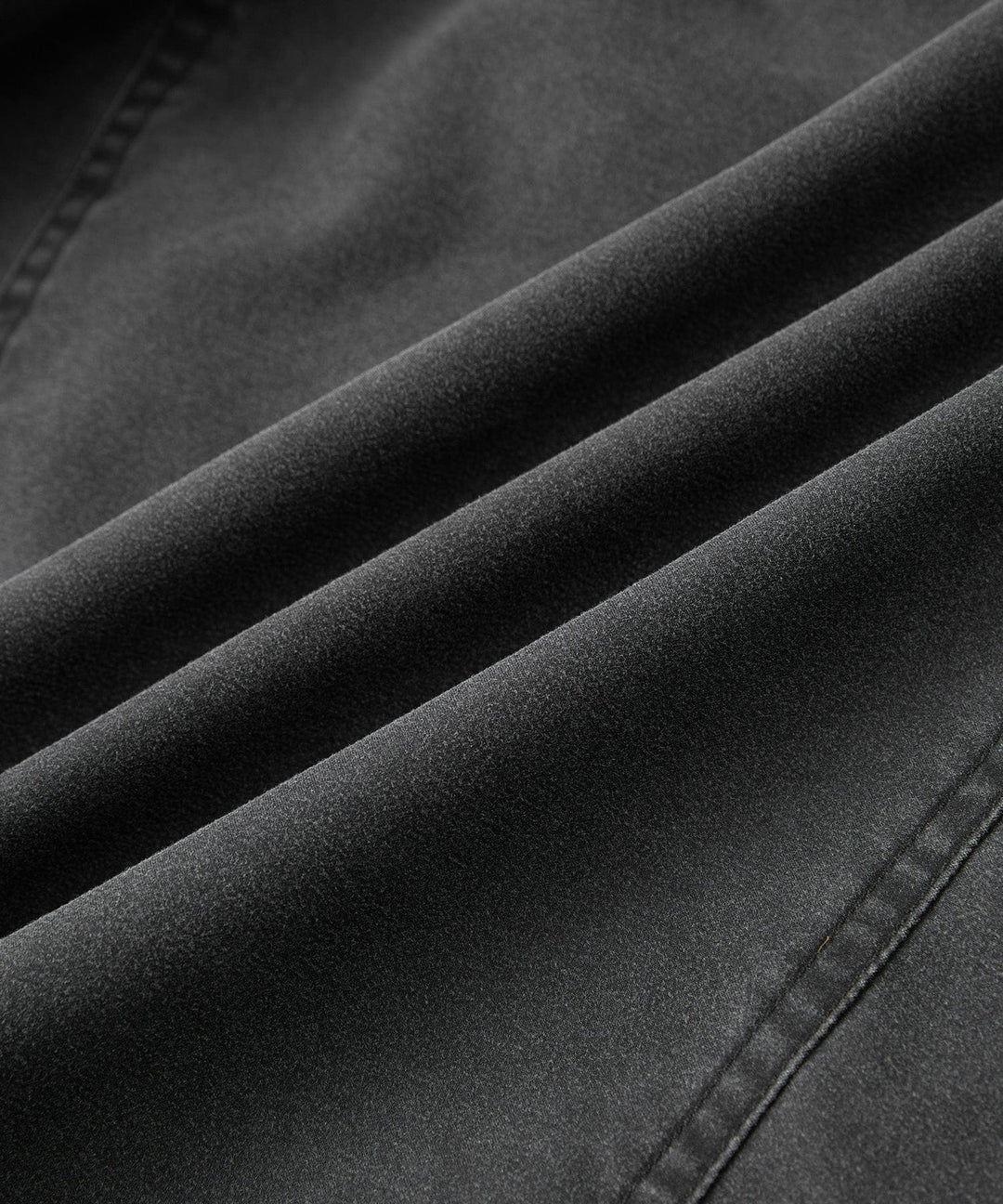 Men's charcoal canvas jacket, laid flat, displaying its rugged material and classic design.