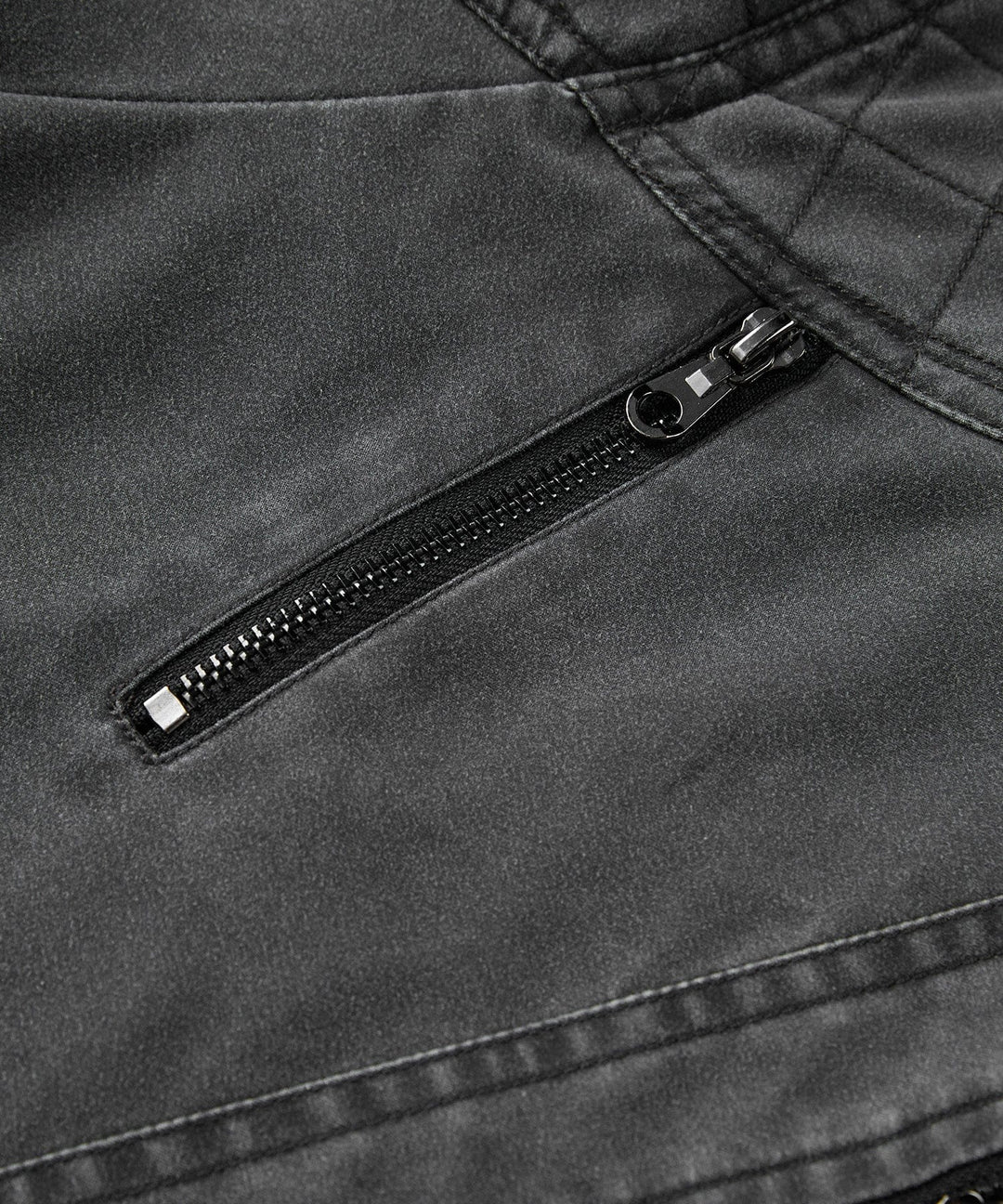 Detailed shot of the utilitarian pockets on a men's charcoal canvas jacket, practical design.