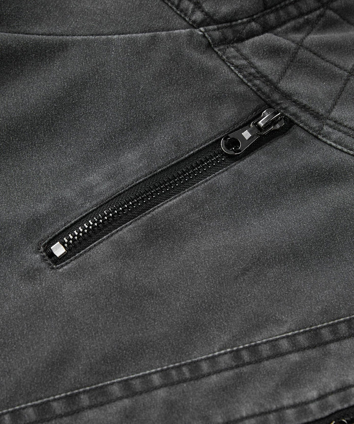 Detailed shot of the utilitarian pockets on a men's charcoal canvas jacket, practical design.