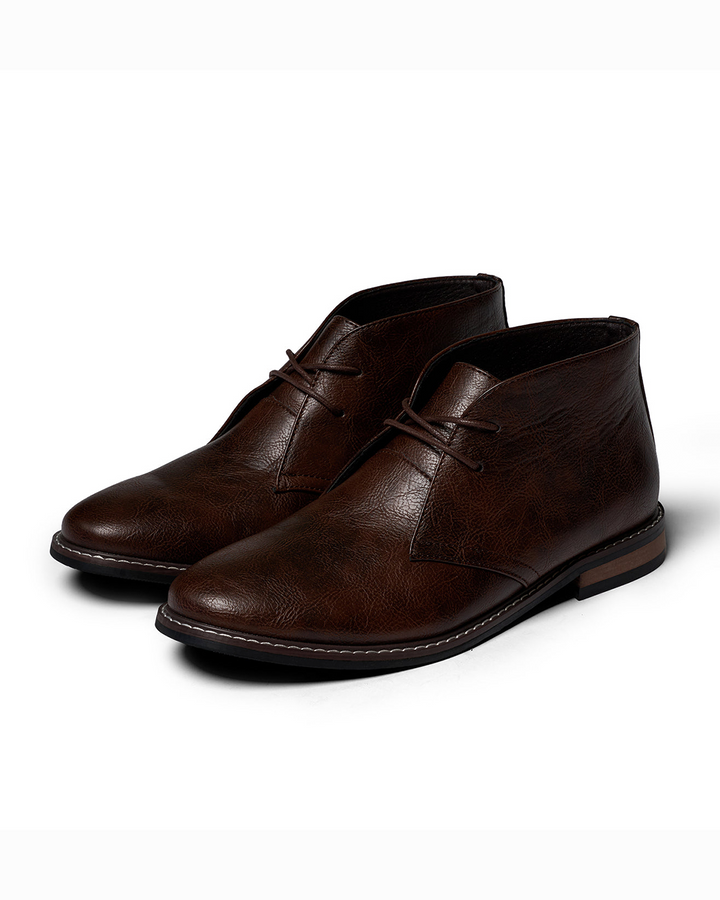Rugged men's dark brown leather ankle boots, side view, natural light, casual style