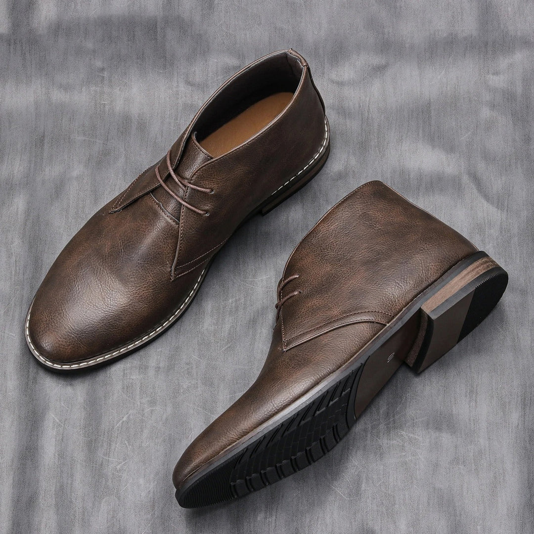 Close-up of stitching on rugged men's dark brown leather ankle boots, craftsmanship, durable