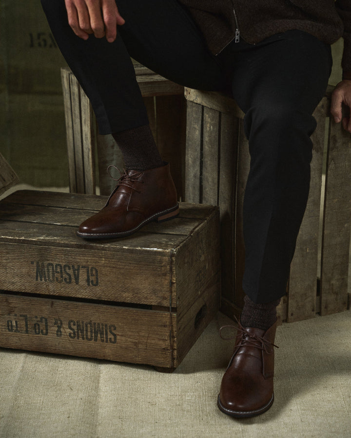 Pair of rugged men's dark brown leather ankle boots, top-down view, comfortable, everyday wear