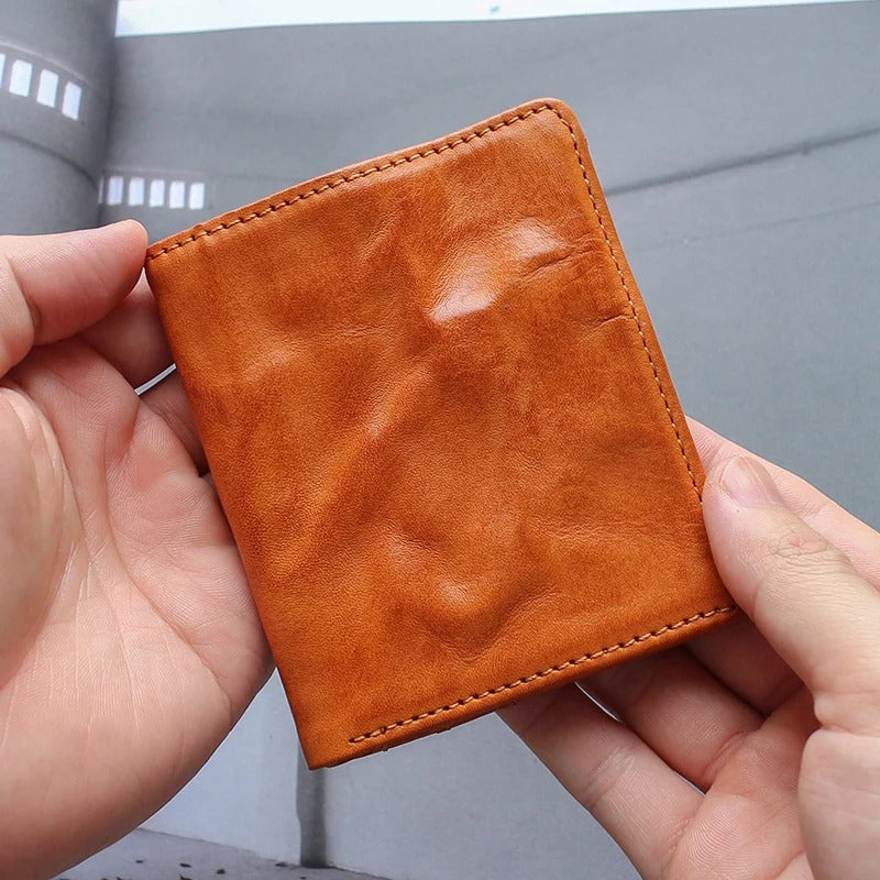 Closed full grain leather tri-fold wallet for men, showcasing rich texture and compact design
