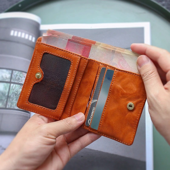 Front view of a slim men's full grain leather tri-fold wallet, ideal for everyday carry