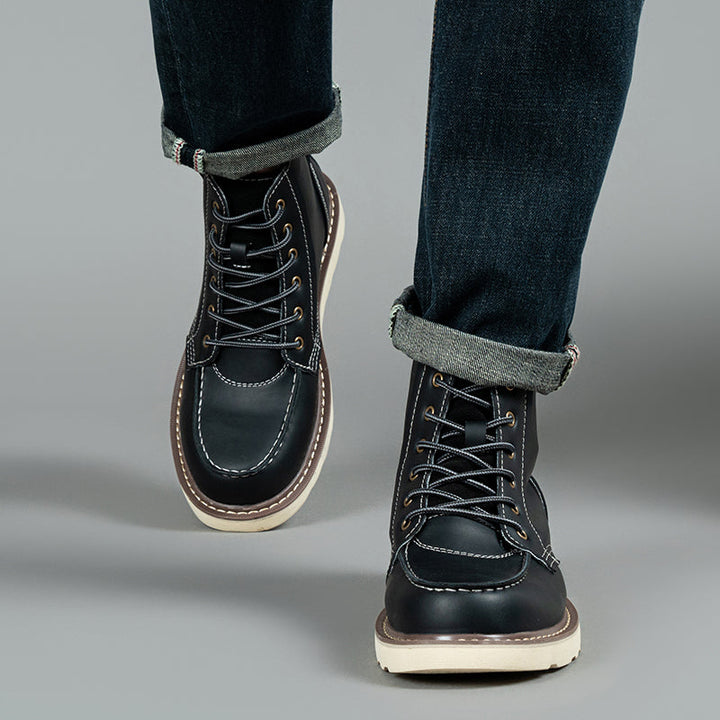 Close-up of the metal eyelets on a black waterproof men's chukka boot for strong lacing