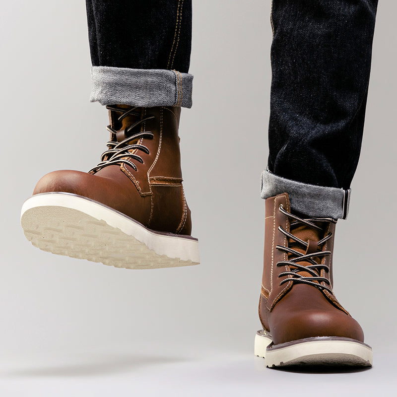 Close-up of the toe cap on a brown rugged waterproof men's chukka boot, showing protection