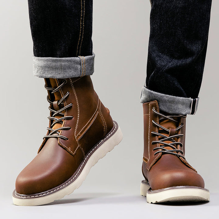 Black men's waterproof chukka boots, spotlighted to bring out the details of their durable build