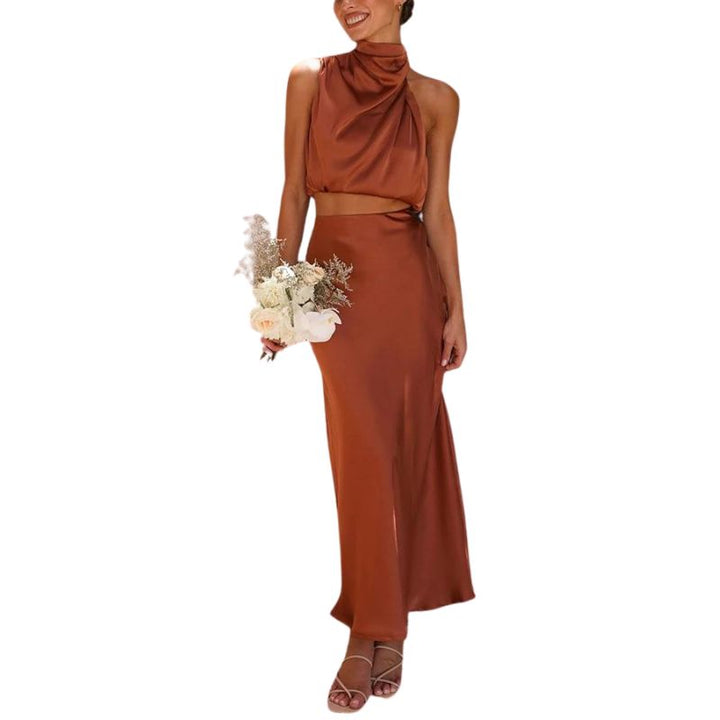 Elegant women's brown & white satin two-piece set with halter neck top & ankle-length skirt, perfect for summer occasions.