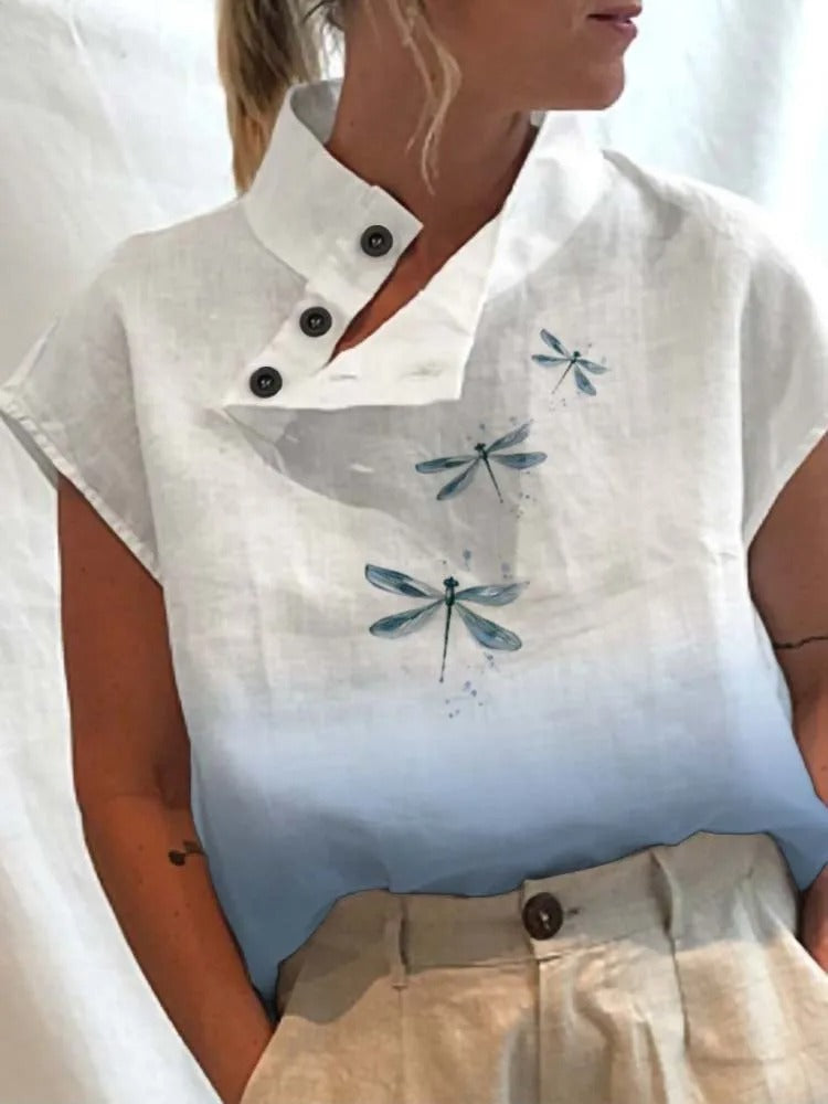 Stylish ladies short-sleeve blouse featuring a vibrant, playful floral print for summer fashion.