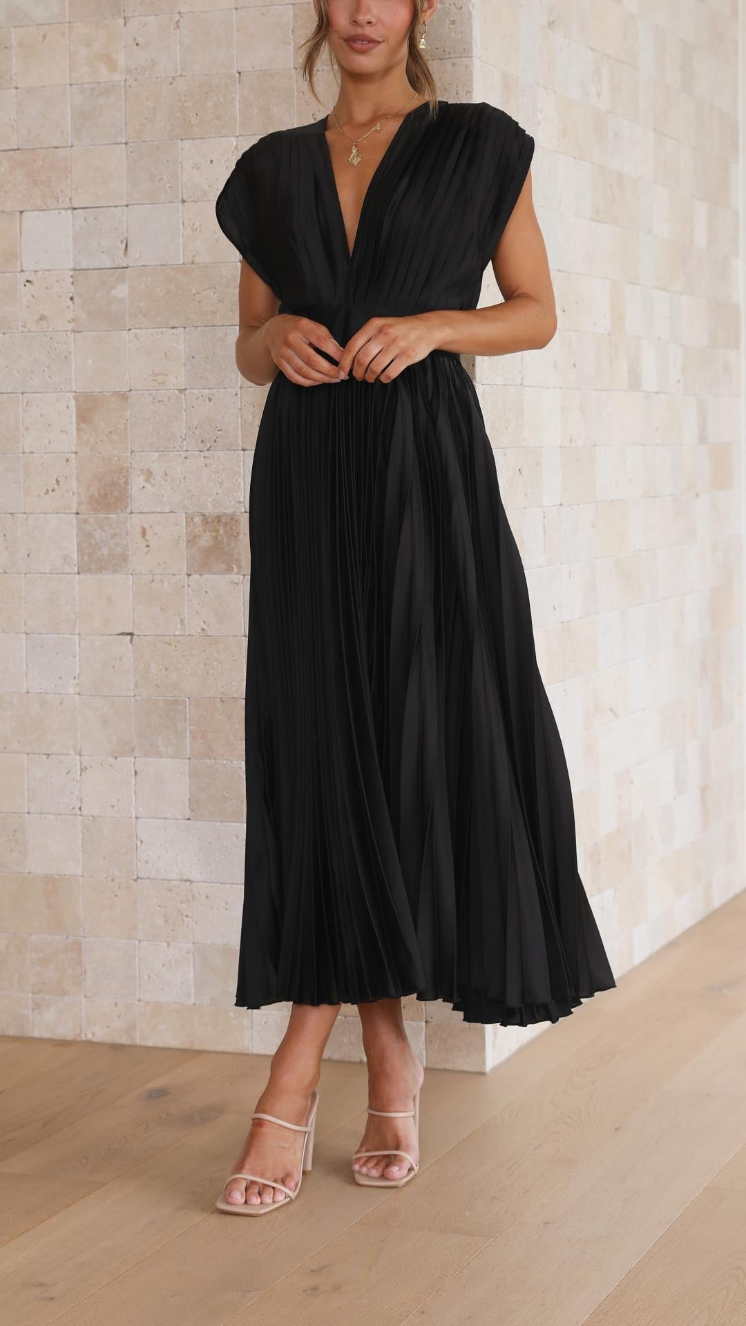 Silk pleated maxi dress with V-neck in rose red, featuring a high waist and elegant flowing pleats for a sophisticated look.