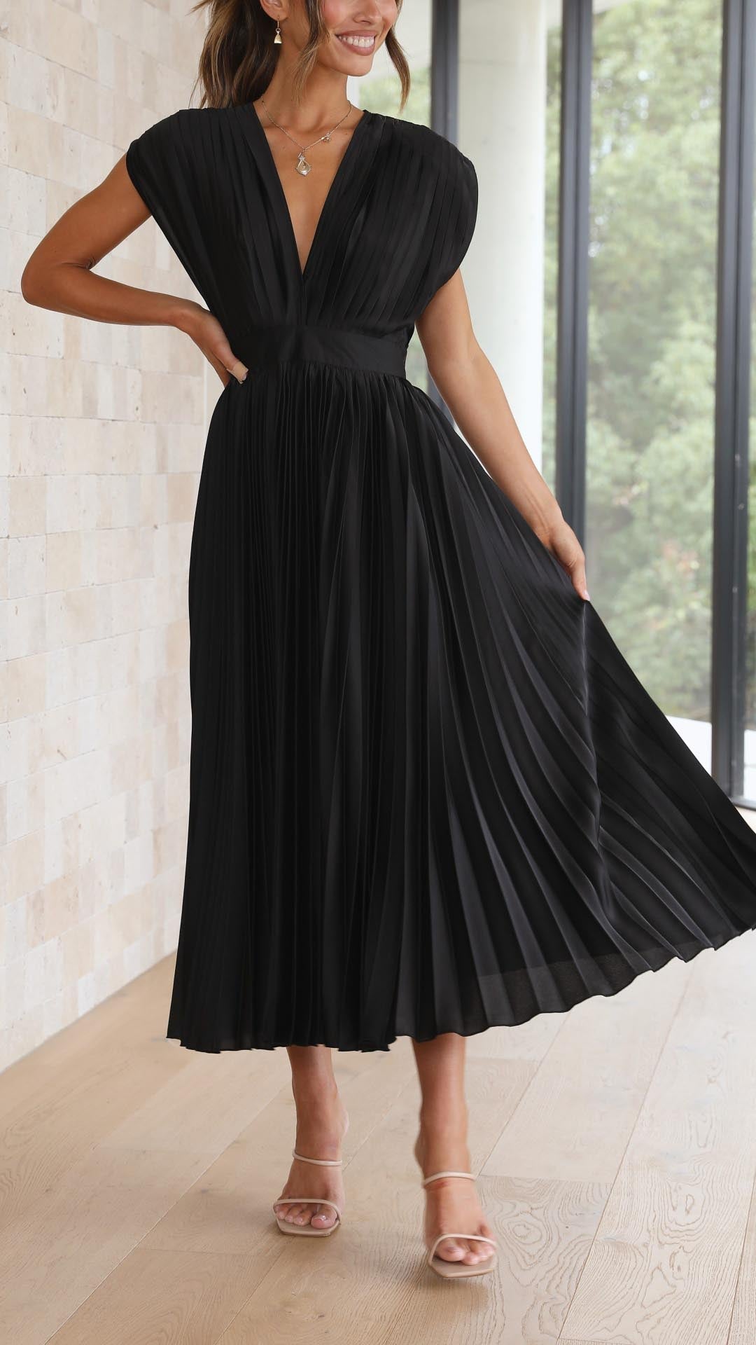 Silk pleated maxi dress with V-neck in rose red, featuring a high waist and elegant flowing pleats for a sophisticated look.