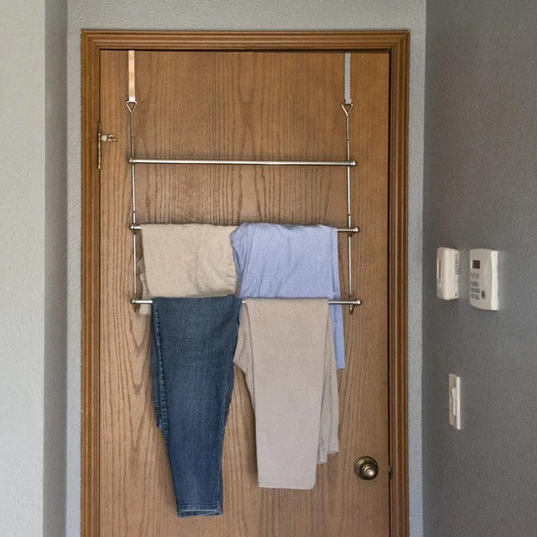 "Sleek metal over door towel bar rack with four rods, maximizing bathroom space for towel storage and organization."