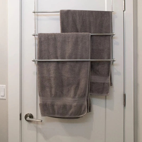 "Sleek metal over door towel bar rack with four rods, maximizing bathroom space for towel storage and organization."