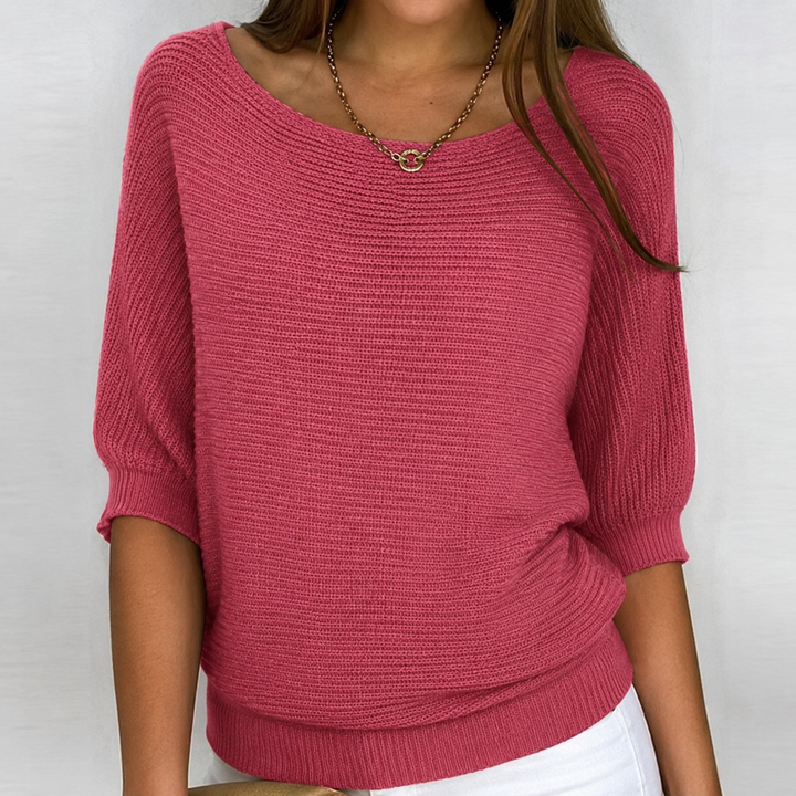 Oversized women's knit top with 3/4 sleeves, crafted from soft fabric for a comfortable, versatile spring or fall style.