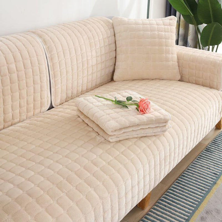 Close-up of quilted flannel sofa cover texture, highlighting the cozy, durable, and pet-friendly fabric.