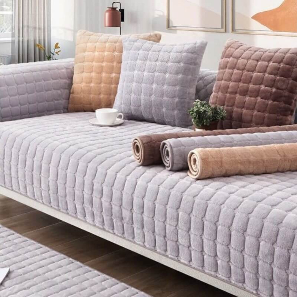 Full coverage view of a flannel sofa cover on a couch, demonstrating its scratch-resistant & anti-slip features.