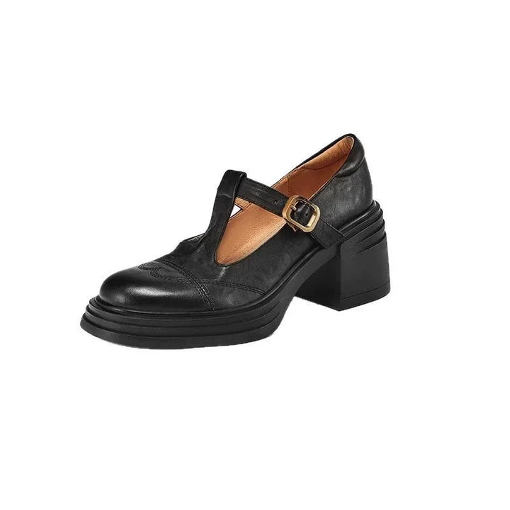 Close-up of women's leather T-strap block heel shoe displaying strap details and classic design.