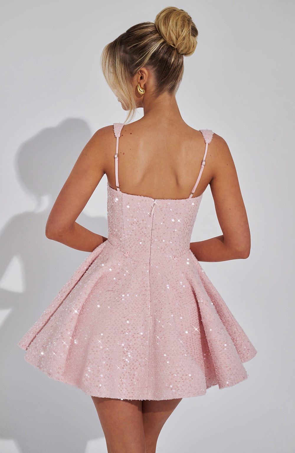 A-line sparkling backless mini dress for women with a statement bow. Perfect for glamorous cocktail parties.