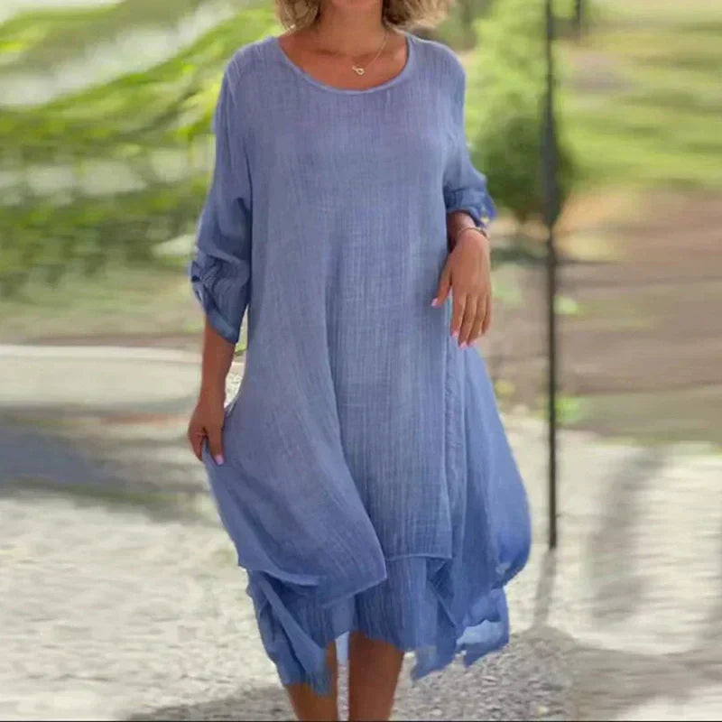 Close-up of the women's layered midi dress showing asymmetric hem detail and flowy, comfortable fabric.