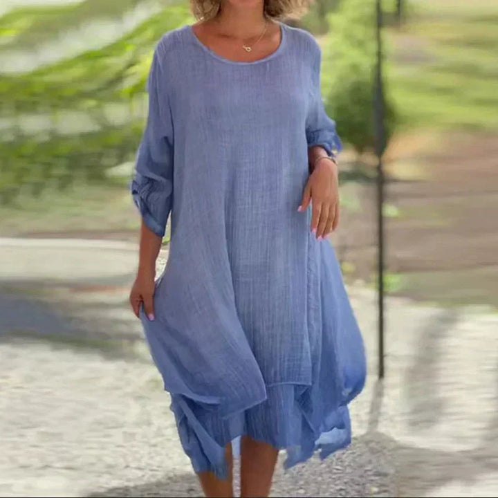 Close-up of the women's layered midi dress showing asymmetric hem detail and flowy, comfortable fabric.