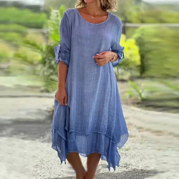 Flowy women's midi dress, layered design, 3/4 sleeves. Elegant & versatile for summer, available in pink & blue.