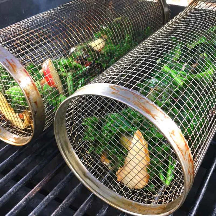 "Stainless steel BBQ grill basket with rotating design for even grilling of veggies and meats, enhancing cooking flavors."