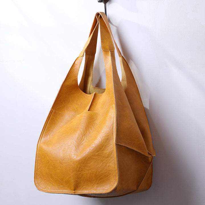 Modern women's oversized shoulder bag, a versatile large capacity tote and essential everyday fashion accessory.