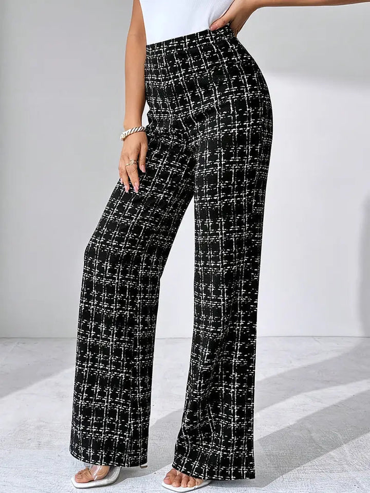 Close-up of the plaid pattern on women's flared knit trousers, high-waisted detail.