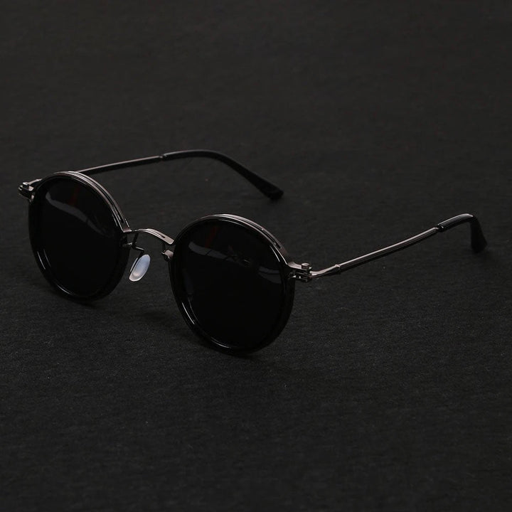 Close-up of gold metal temples on sleek unisex polarized round sunglasses, emphasizing quality.