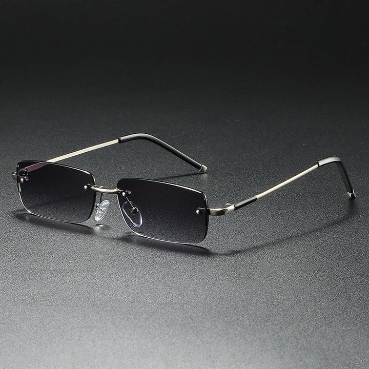 Sleek gold rimless rectangular sunglasses for men & women. Features fashion-forward gradient lenses & UV protection.