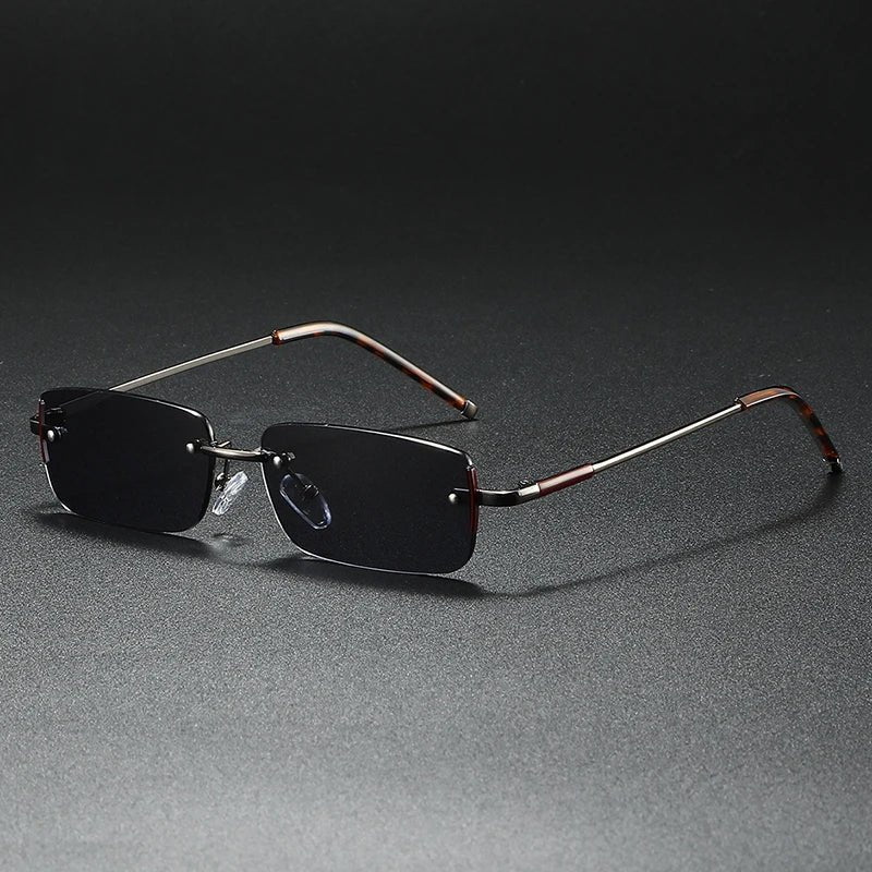 Lightweight rimless rectangular sunglasses with elegant gold accents and gradient lenses. Unisex fashion eyewear.
