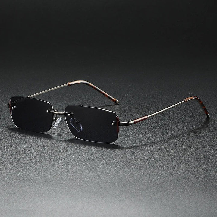 Lightweight rimless rectangular sunglasses with elegant gold accents and gradient lenses. Unisex fashion eyewear.