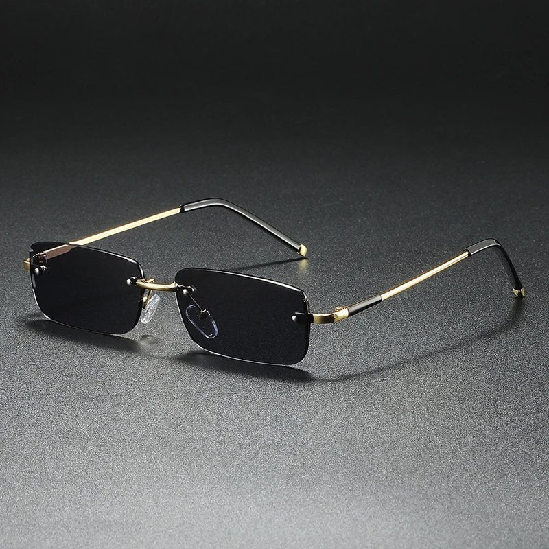 Modern unisex rimless gold rectangular sunglasses with gradient lenses. Offers UV protection & a lightweight design.