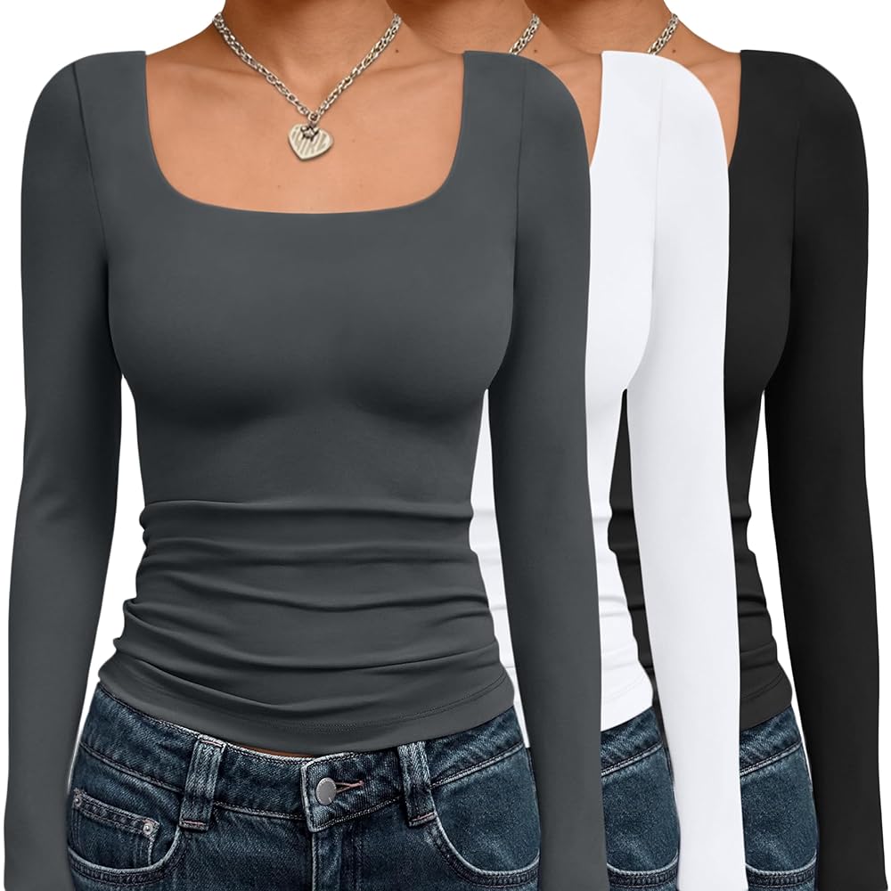 Model wearing a white women's ribbed long sleeve scoop neck top, perfect as a layering piece with stretch fabric.