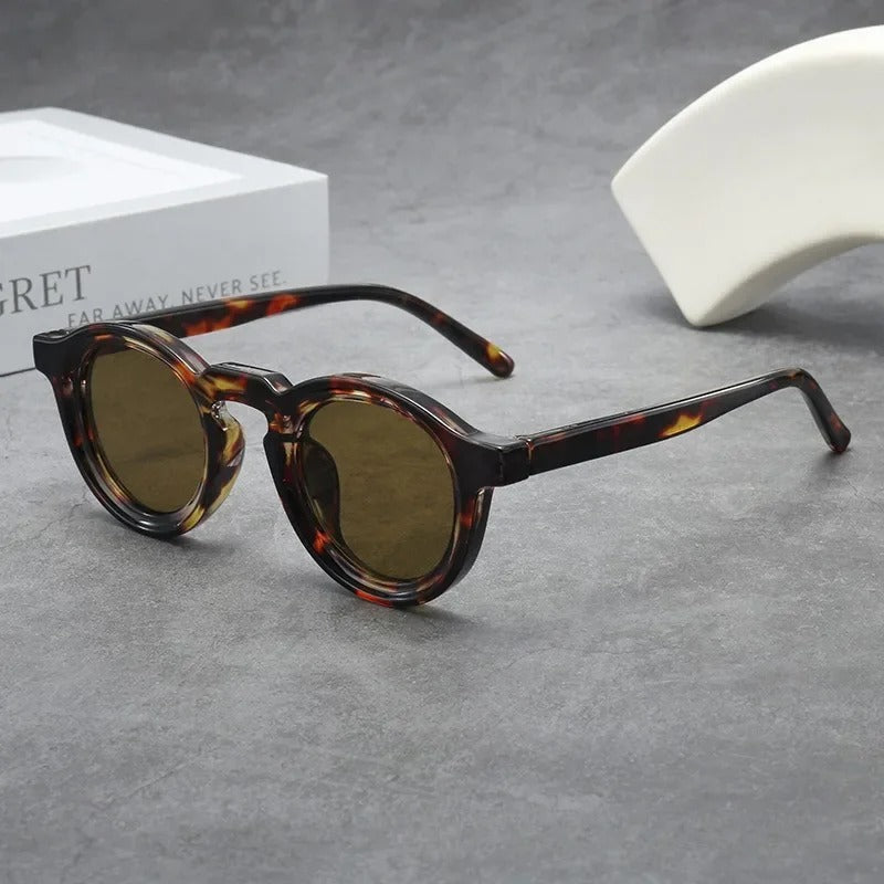 Sleek graphite round tinted sunglasses, a stylish unisex accessory for everyday wear. Lightweight eyewear.