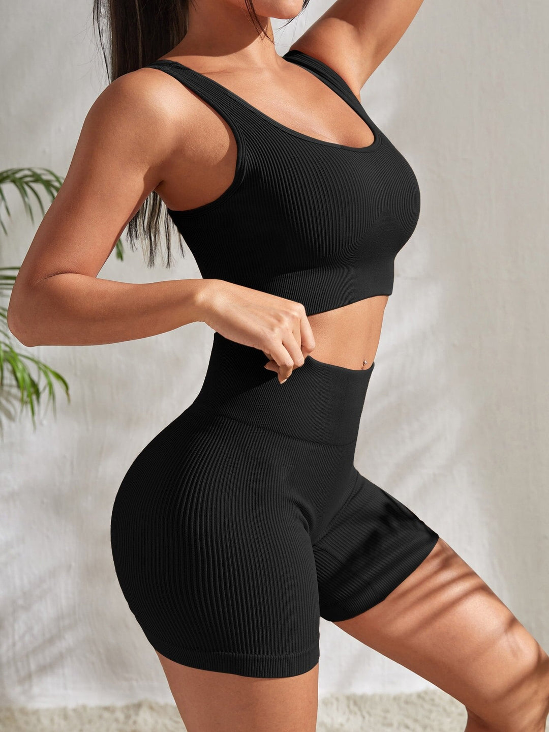 Versatile women's gym outfit: high-waist shorts & crop sports top, ideal for fitness, yoga, and running.