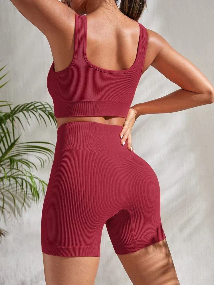 Comfortable women's yoga outfit: high-waist athletic shorts & supportive sports bra crop top for flexibility.