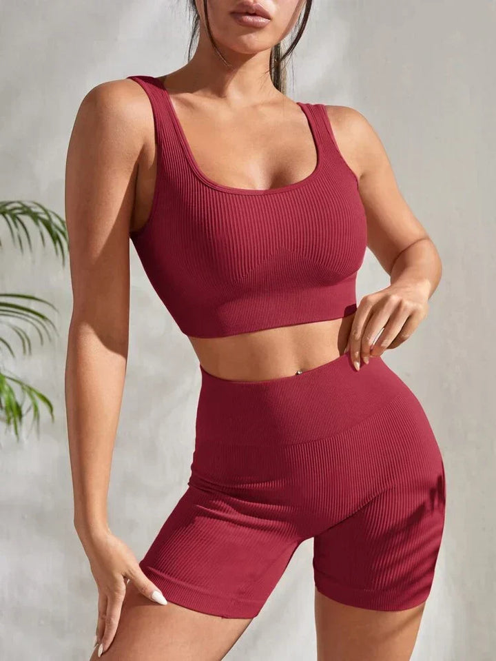 Stylish women's activewear set: high-waist athletic shorts & sports crop top, perfect for gym or yoga.