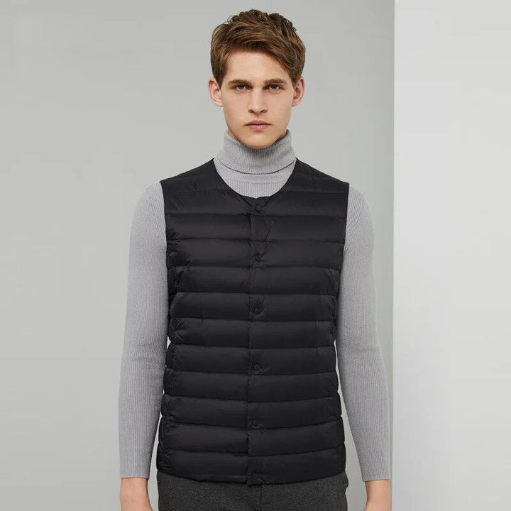Travel-friendly men's down vest, offering lightweight warmth and freedom for versatile fashion.