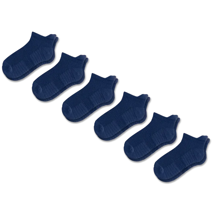 Side view of a foot wearing a unisex ankle compression sock, showing ankle support