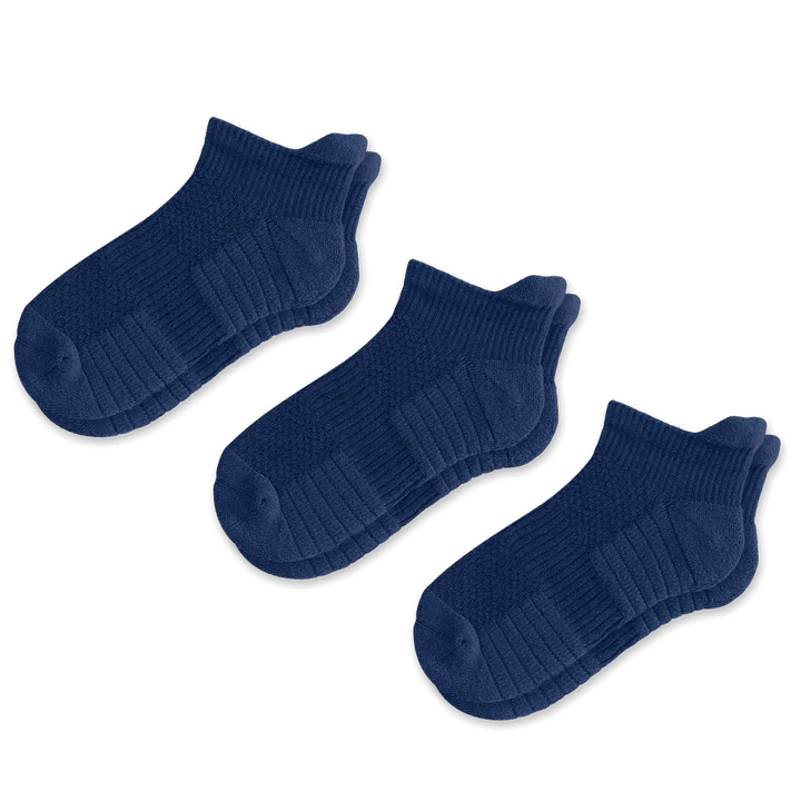 Stack of multiple pairs of unisex ankle compression socks, ready for retail display