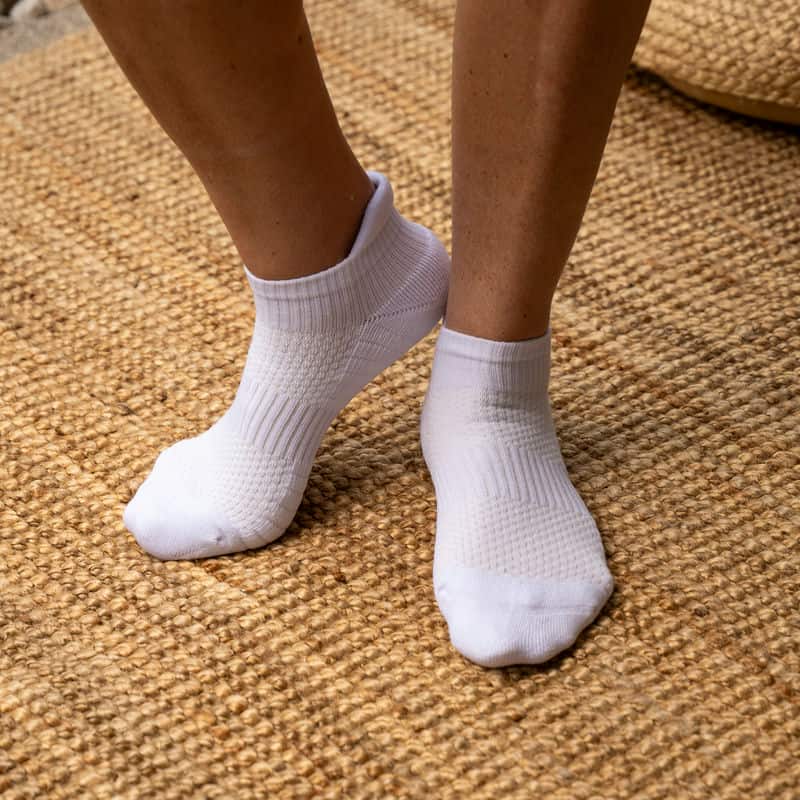 Pair of black unisex ankle compression socks, ideal for athletic wear and everyday support