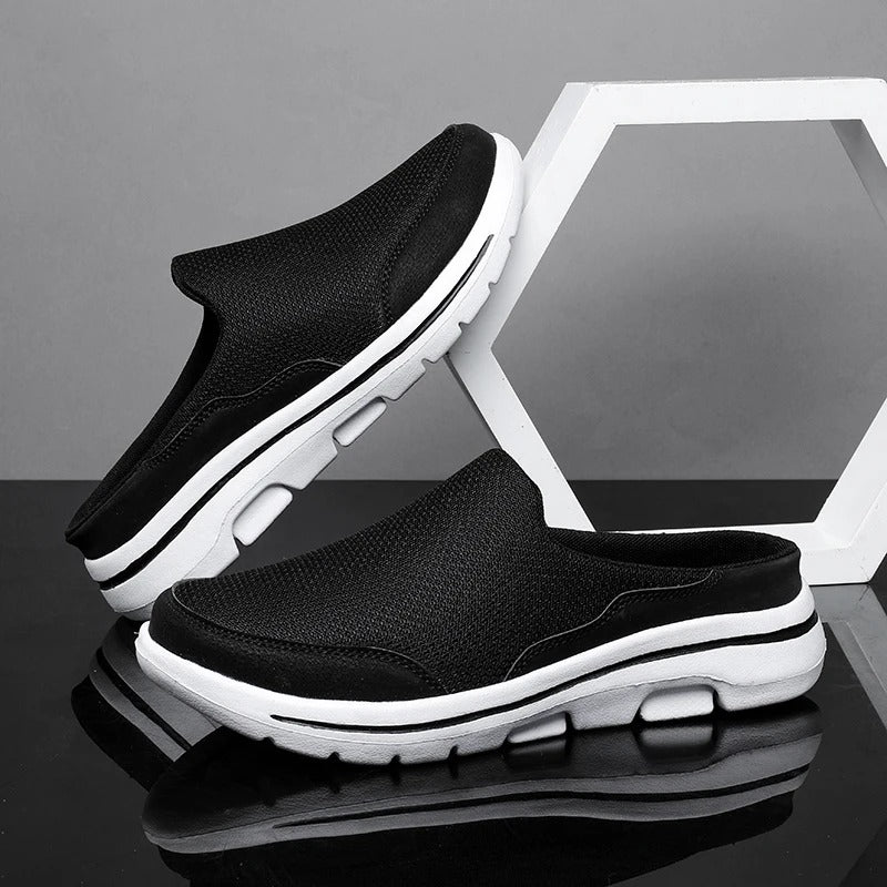 Athletic backless comfort sneaker slides with a minimalist design, emphasizing breathability.