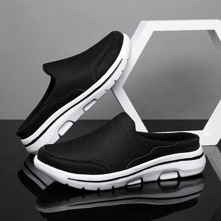 Athletic backless comfort sneaker slides with a minimalist design, emphasizing breathability.