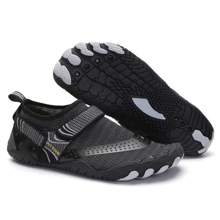 Barefoot water shoes in action on a sandy beach, perfect for swimming & water sports. Quick-dry comfort.